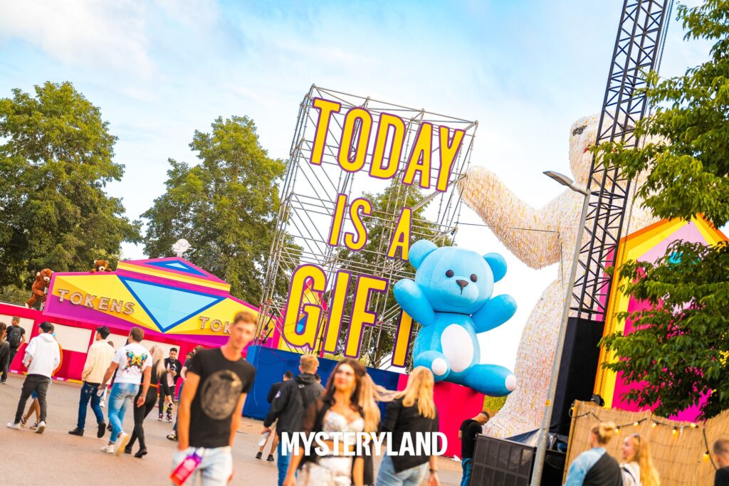Inflatable blue teddy bear of 5 meters high as decoration at festival - soft plush appearance and impressive eye-catcher at Mysteryland Festival.
